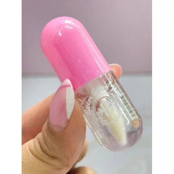 Brillo Labial Hidratante Mini Bloom Mimosa transparente con tapa rosa, ideal para labios radiantes. Diseño compacto tipo cápsula.