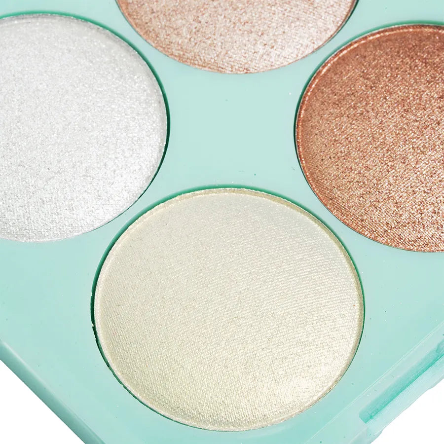 Close-up of Bibi Boom shimmering makeup highlighter palette with four metallic shades in mint green case