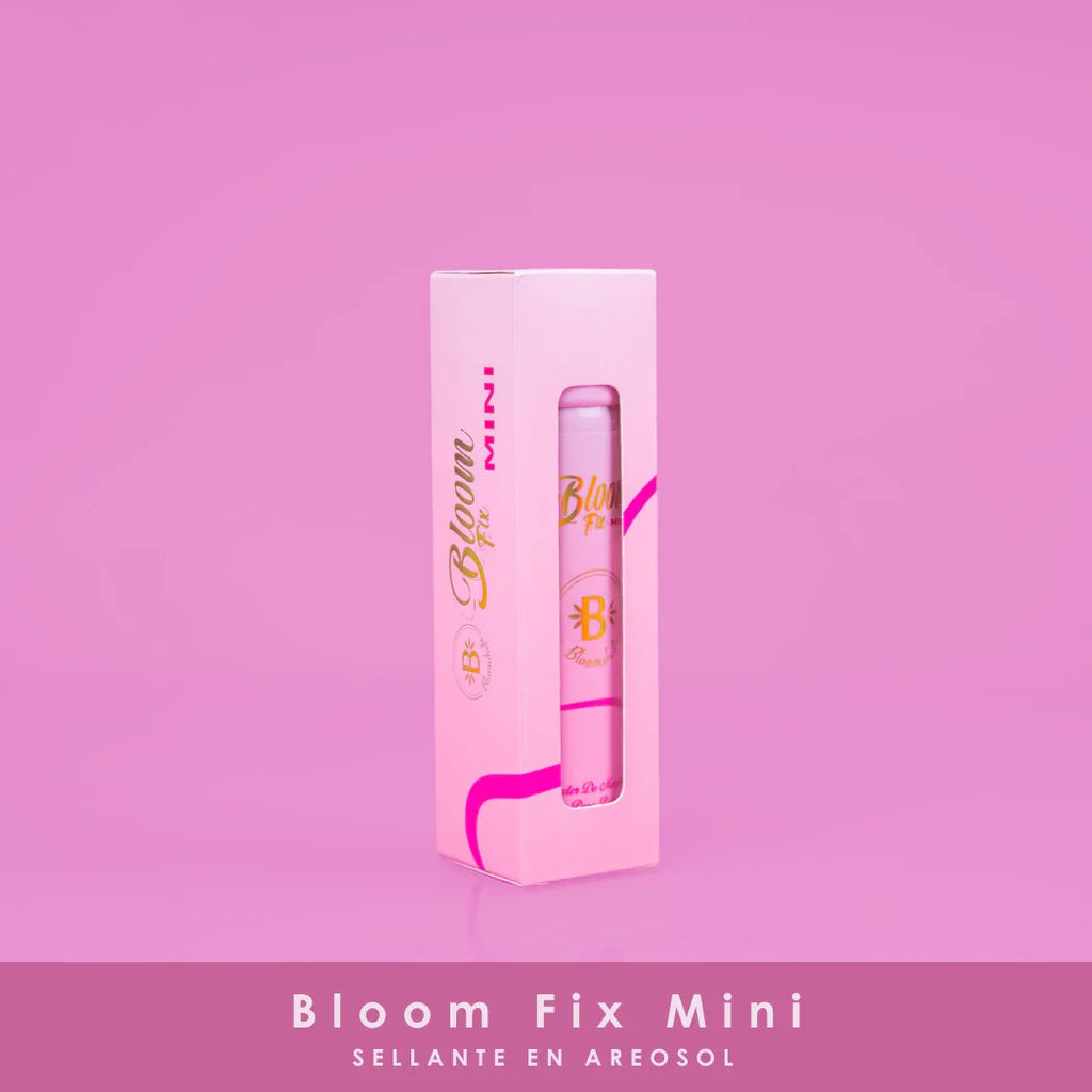 Pink Bloom Fix Mini aerosol setting spray with gold and pink packaging on pink background, beauty product