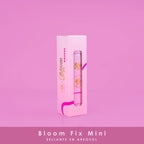 Pink Bloom Fix Mini aerosol setting spray with gold and pink packaging on pink background, beauty product