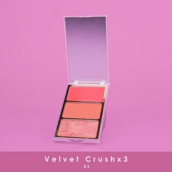 Velvet Crushx3 makeup palette with three shades in terracotta tones, open with a mirror, on pink background